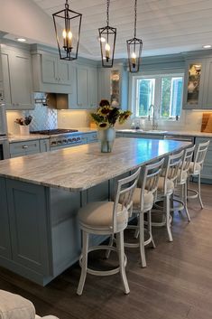 a large kitchen island with chairs around it