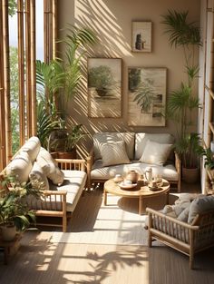 a living room filled with lots of furniture and plants on top of wooden flooring