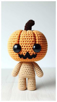 a crocheted pumpkin with black eyes and a mustache on it's head