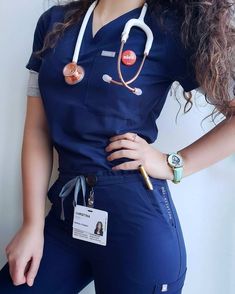 a woman in scrubs is standing with her hands on her hips and wearing a stethoscope