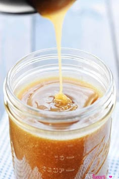 a glass jar filled with liquid sitting on top of a table