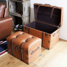 two suitcases sitting next to each other on the floor in front of a couch