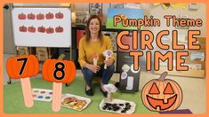 a woman sitting on the floor in front of pumpkin themed items