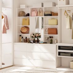 a white closet filled with lots of purses and handbags on top of shelves