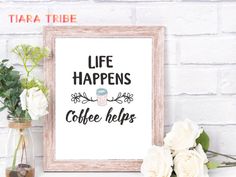 there is a sign that says life happens coffee helps and flowers in front of it