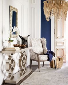 a living room filled with furniture and a chandelier