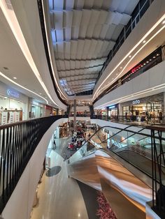 the interior of a shopping mall with escalators