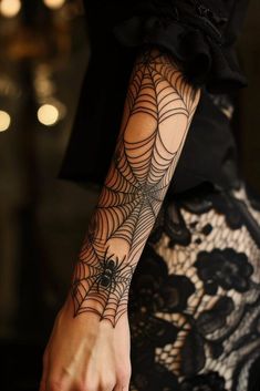 a woman with a spider web tattoo on her arm