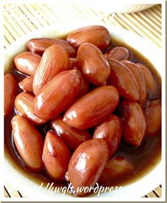 a bowl filled with lots of almonds on top of a table