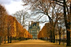 an old building surrounded by trees in the fall