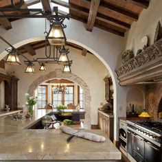 a large kitchen with an arched ceiling and marble counter tops