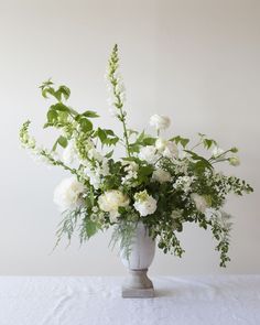 a vase filled with white flowers on top of a table