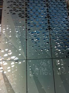 a close up of a metal structure with water drops on the glass and in front of it