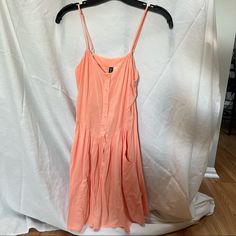 Never Worn Peach Color Dress With Adjustable Straps. Buttons Down The Middle And Deep Pockets. Peach Sundress Mini Dress For Summer, Peach Sundress For Summer, Peach Mini Sundress For Summer, Peach Mini Dress For Summer Vacation, Spring Peach Sundress For The Beach, Spring Peach Sundress For Beach, Summer Vacation Peach Mini Dress, Spring Peach Beach Sundress, Casual Peach Mini Dress For Vacation