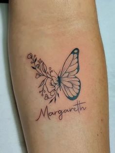 a small butterfly tattoo on the arm with words and flowers around it that reads, margonethh