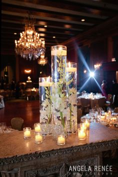 the centerpieces are filled with candles and flowers