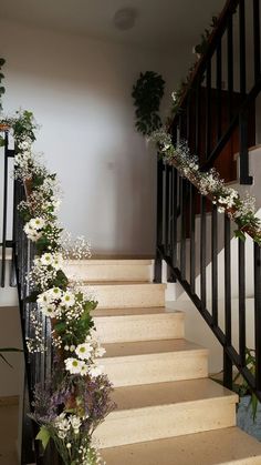 some white flowers are growing on the stairs