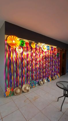 a room filled with lots of different colored paper decorations on the wall and flooring