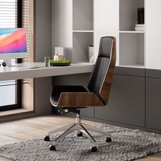 an office chair sits in front of a desk with a computer monitor on the wall