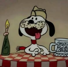 a cartoon dog sitting on top of a table next to a cup