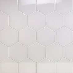 a white tiled wall with hexagonal tiles