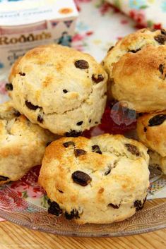 biscuits with chocolate chips on a plate next to a carton of yogurt