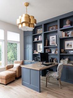 a home office with built - in bookcases, desk and chair is shown