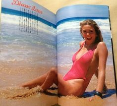 a woman in a pink swimsuit is laying down on the beach