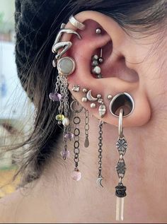 a woman with ear piercings and chains