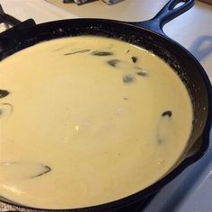 a pan filled with food sitting on top of a stove next to a spatula