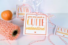 some oranges and twine on a table with tags that say you are such a cute valentine