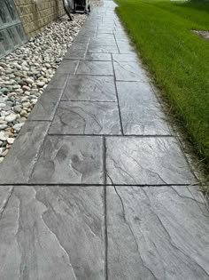 the walkway is lined with stones and grass