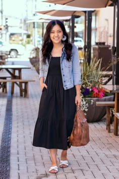 Top 18 Soccer Mom Outfits To Look Stylish In 2023 Black Dress With Jeans Jacket, Western Outfits Women Jean Jacket, Denim Jacket With Black Dress, Black Midi Dress Outfit Summer, Jeans With Slides, Black Dress Jean Jacket Outfit, Black Dress With Jean Jacket, Boho Jackets For Women, White Slides Outfit