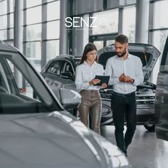 two people looking at cars in a showroom with the words semz on it