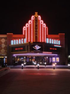 the marquee is lit up at night with bright lights on it's sides