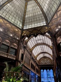 the inside of a building with many windows and glass roofing on it's sides