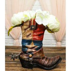 a pair of cowboy boots with flowers in them