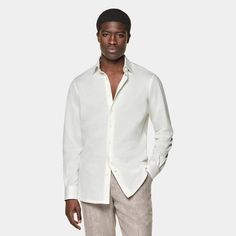 This off-white shirt is tailored to a casual tailored fit and features a classic collar, single cuff, and a French placket. White Shirt With Hidden Button Closure For Spring, White Long Sleeve Dress Shirt With Concealed Placket, Beige Formal Shirt For Summer, Beige Formal Summer Shirt, White Slim Fit Dress Shirt For Summer, Classic Summer Shirt With Concealed Placket, Classic Semi-formal Linen Shirt, Classic Linen Shirt For Semi-formal Occasions, Timeless Summer Shirt With Spread Collar