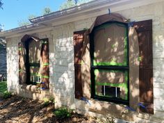 a house with three windows and some tape taped around them