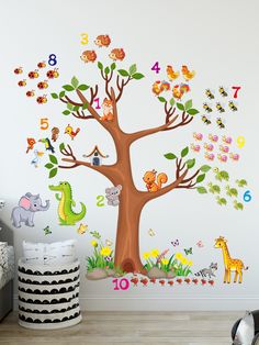 a child's room with an animal tree and numbers on the wall