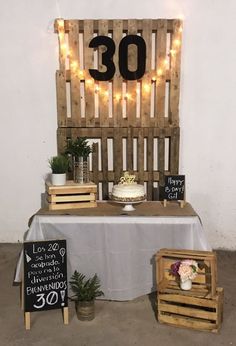 a table topped with a cake and wooden crates