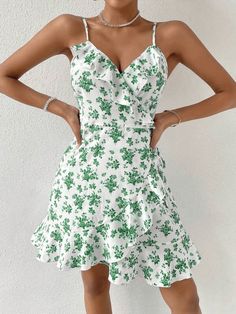 This beautiful WYWH Floral Print Ruffle Trim Wrap Knot Side Cami Dress is the perfect addition to your summer wardrobe. Its lightweight and flowy fit is crafted from 95% Polyester and 5% Elastane fabric, with fresh all-over floral print accents and ruffle and wrap detail that add a touch of boho-chic to your look. The sleeveless spaghetti strap dress features a high waist and regular fit, perfect for twirling in the sunshine. Style: Boho Pattern Type: Floral, All Over Print Details: Ruffle, Wrap Flirty V-neck Ruffle Dress For Summer, Summer V-neck Ruffle Dress For Garden Party, Elegant Summer Beach Ruffle Dress, Elegant Ruffle Dress For Summer Vacation, Elegant Summer Ruffle Dress For Vacation, Flowy Chiffon Ruffle Dress For Summer, Green Ruffled Mini Dress For Summer, Flirty Flowy Ruffle Dress For Beach, Summer Flowy Chiffon Ruffle Dress