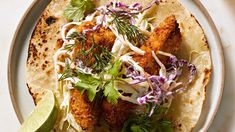 fish tacos with cole slaw and lime wedges