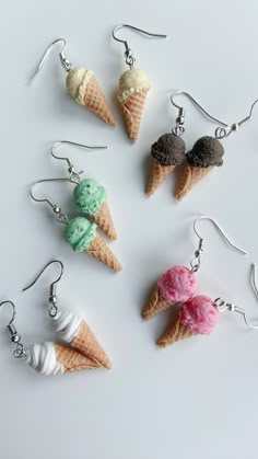 six ice cream cones are shown with dangling earrings