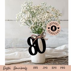 a white vase with flowers in it and the number 80 on it's side