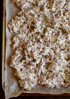 an uncooked cracker cookie sitting on top of a baking sheet