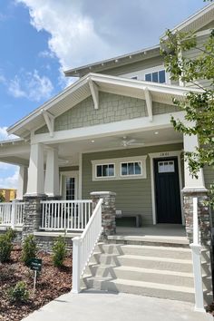 a house with stairs leading up to the front door