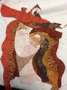 a piece of art that looks like a woman's face is made out of fabric