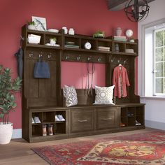 a room with a large rug and some wooden shelves on the wall next to a window