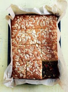 a loaf of bread sitting on top of a pan covered in nuts